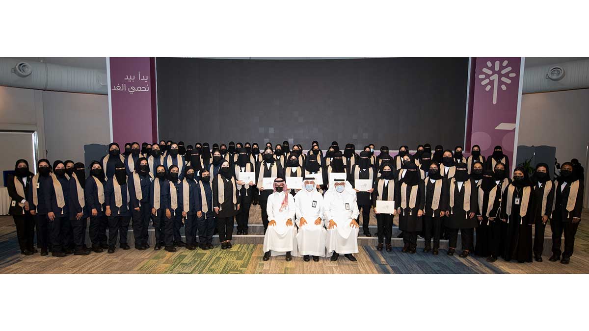 First female graduates industrial security in a group photo with Amin Nasser