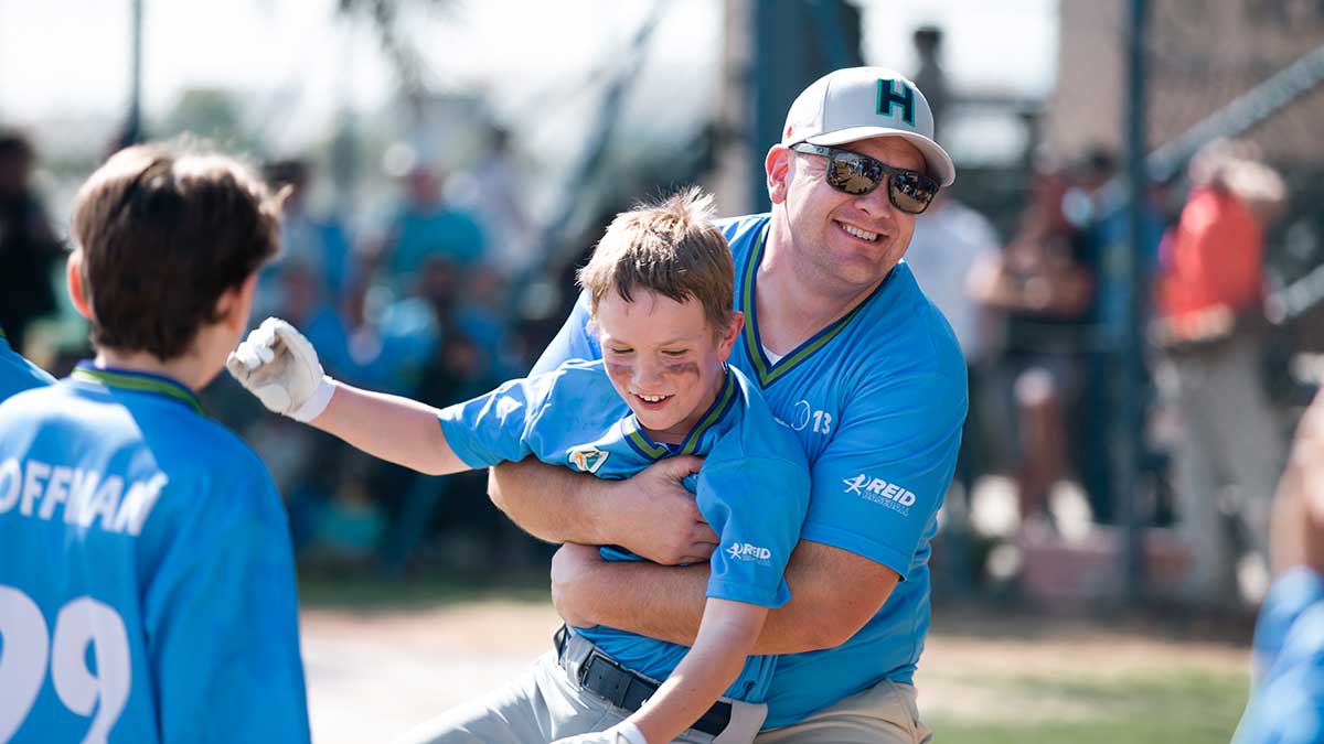 Glenn Makechnie and son Finn celebrate Dhahran Youth Baseball Association in Dubai 2023